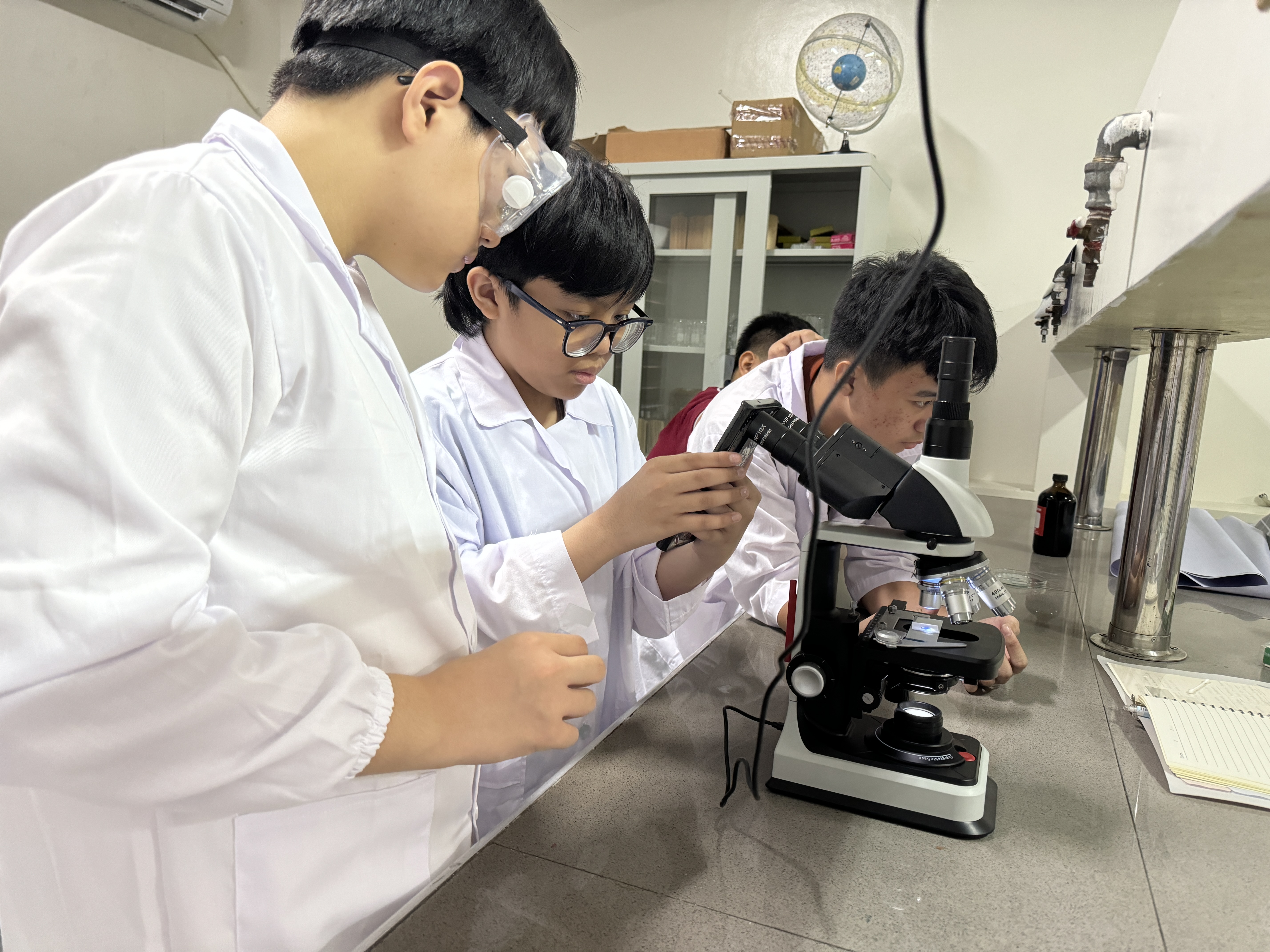 Students participating in a science fair at Philippine Cambridge International School (PCIS), demonstrating their curiosity and enthusiasm for learning through hands-on experiments and presentations.