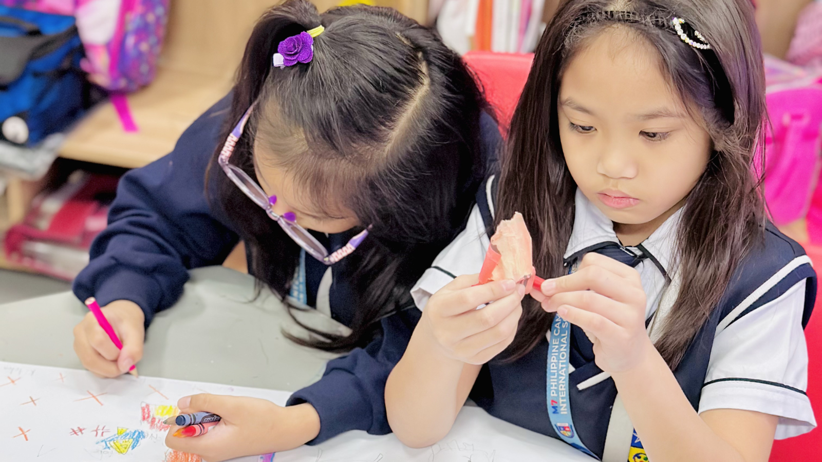 Primary Years Programme (PYP) students focused and working independently on classroom tasks, demonstrating concentration and active learning.
