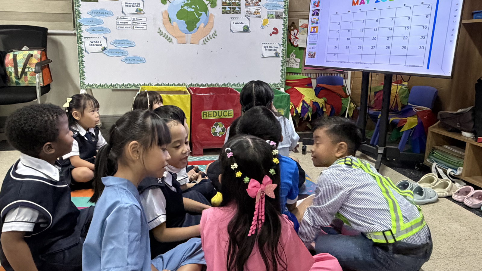 Early Years Programme (EYP) students actively engaged in a group discussion, demonstrating curiosity and social interaction in the classroom.