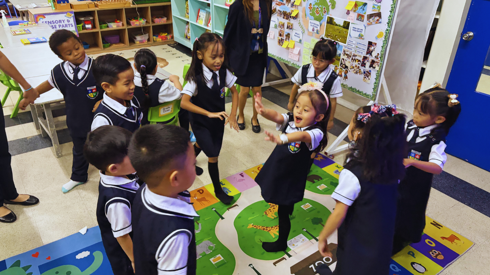 Students actively participate in a small-group discussion, sharing ideas and listening to one another in a collaborative classroom environment where every voice is valued.