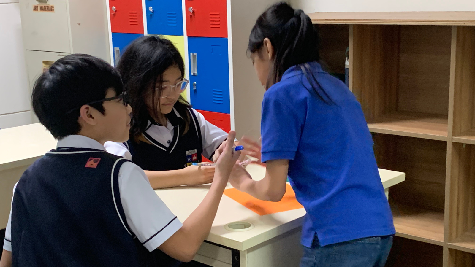 Students collaborate with a teacher during a personalized learning activity at Philippine Cambridge International School in Cavite, demonstrating student-centered education, inquiry-based learning, and the International Baccalaureate (IB) approach in a supportive classroom environment that encourages teamwork, critical thinking, and active participation.